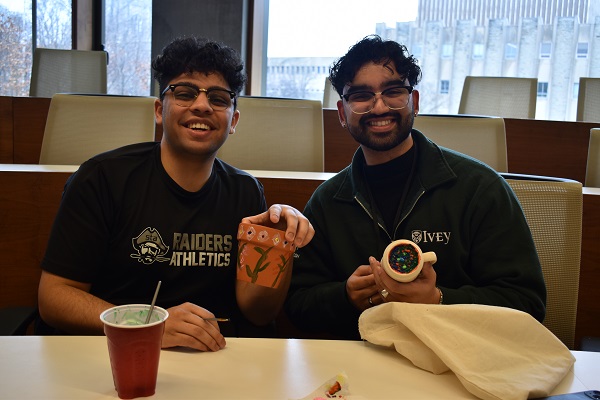 Two attendees at the Entrepreneurship + Painting showcase their creations