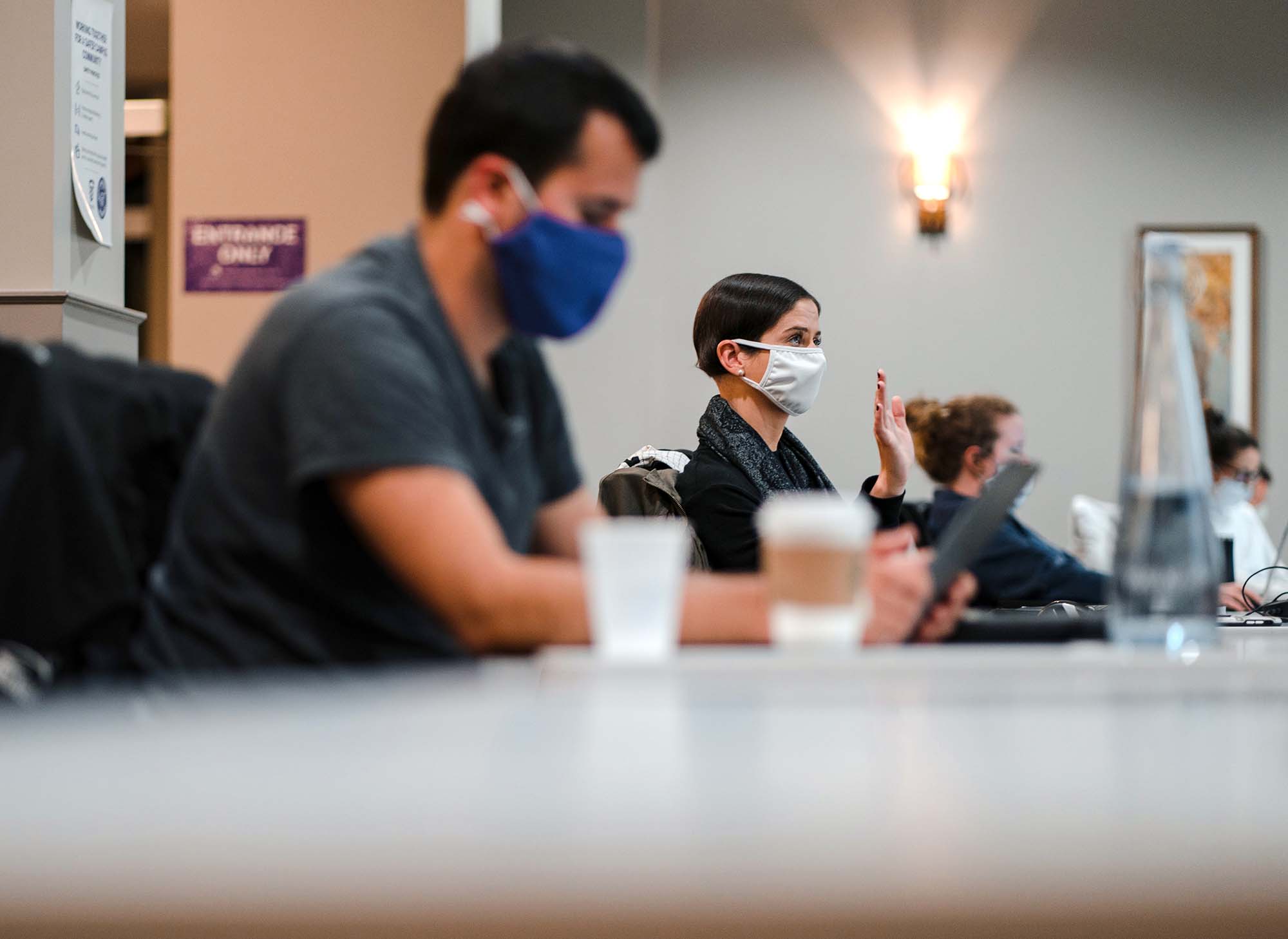 Students in masks listening photo