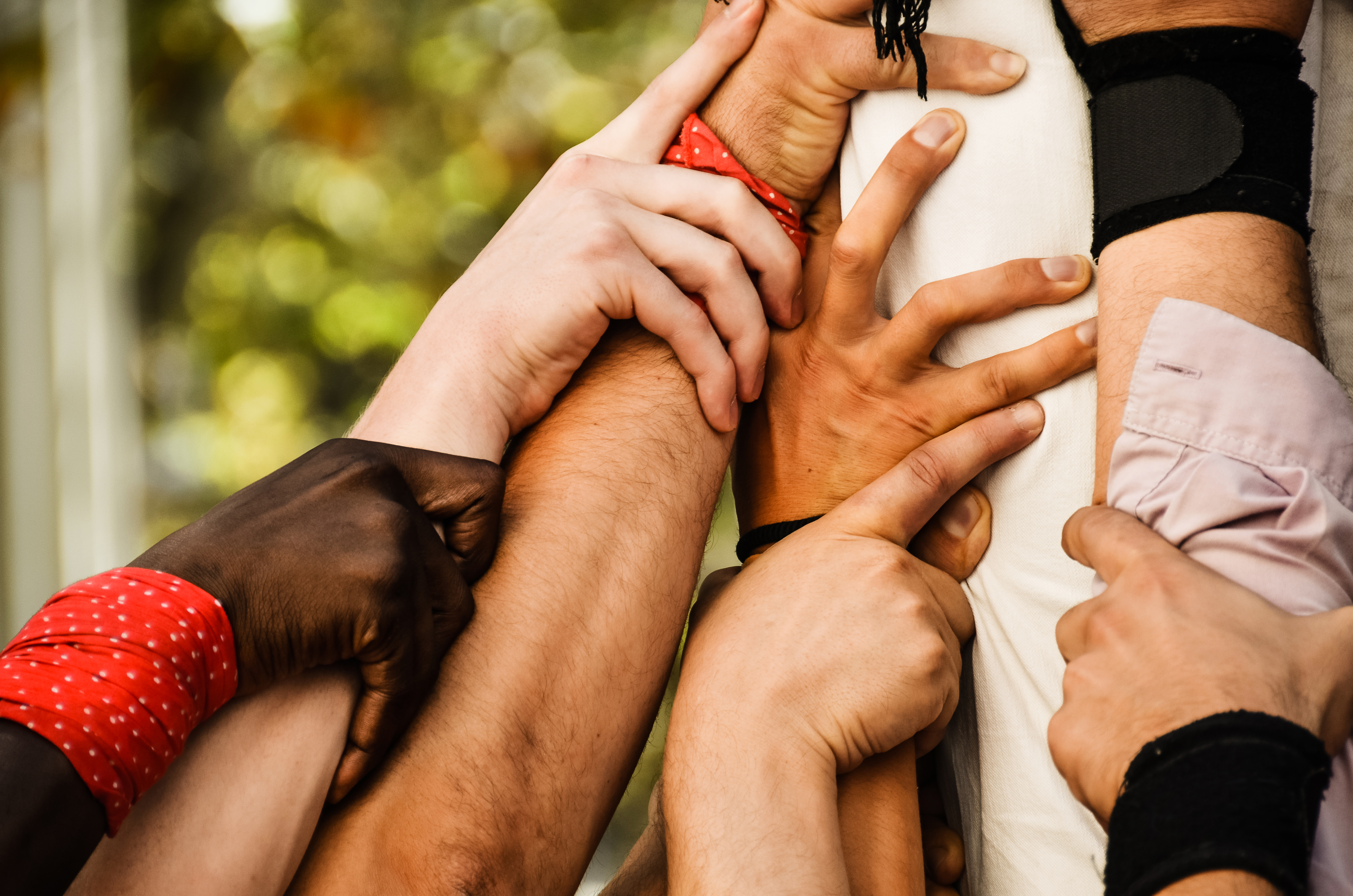 A group of hands all grasping each other