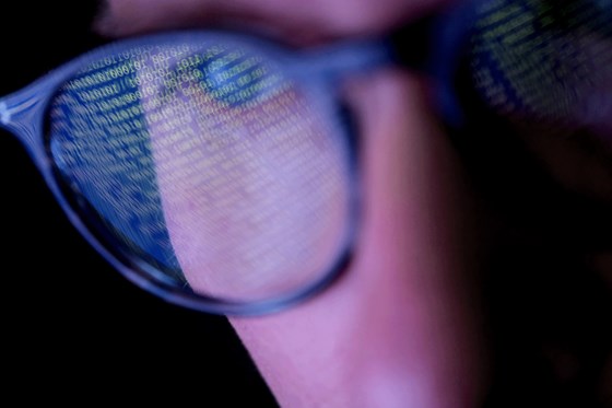 Guy In Glasses Infront Of Binary Code