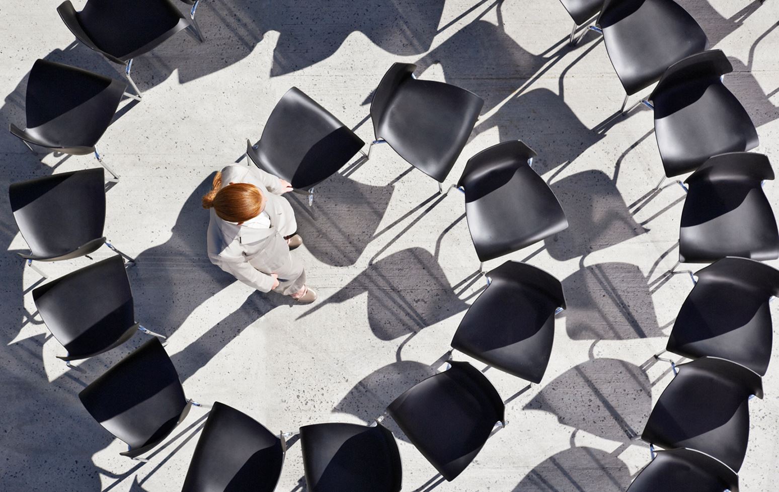 Woman in maze of office chairs