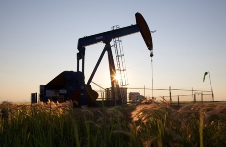 An Oil Pump Jack Pumps Oil In A Field Near Calgary Alberta
