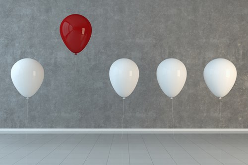 Five White Balloons With One Red