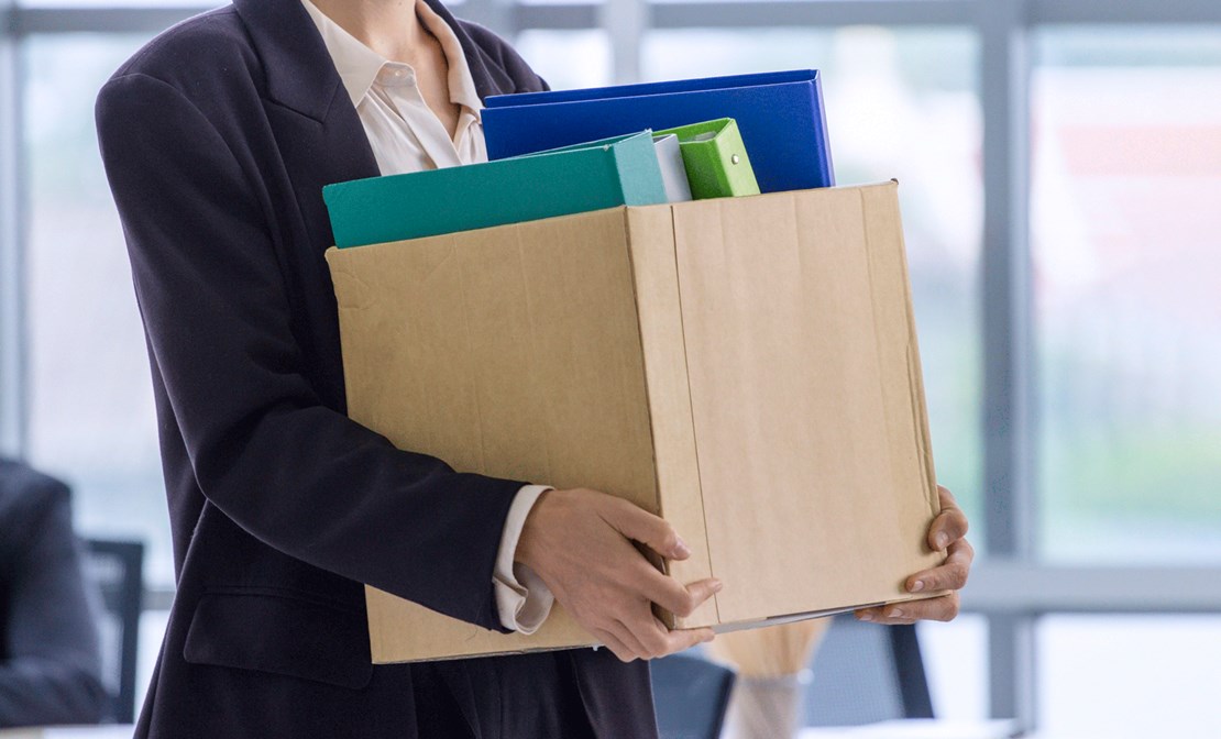 Woman with Box of things leaving Office