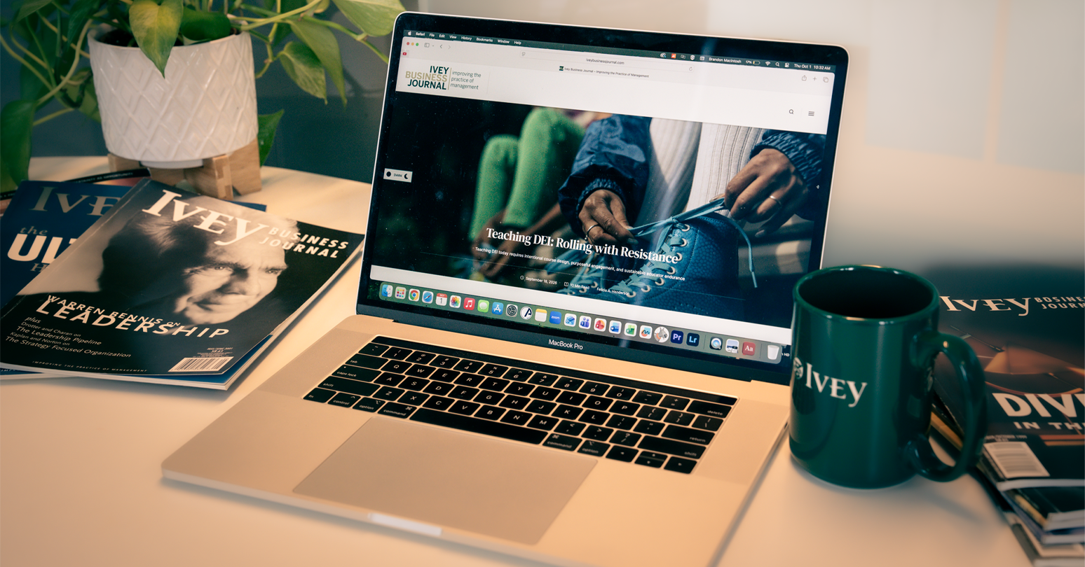 A laptop showing the Ivey Business Journal's website surrounding by copies of the printed publication