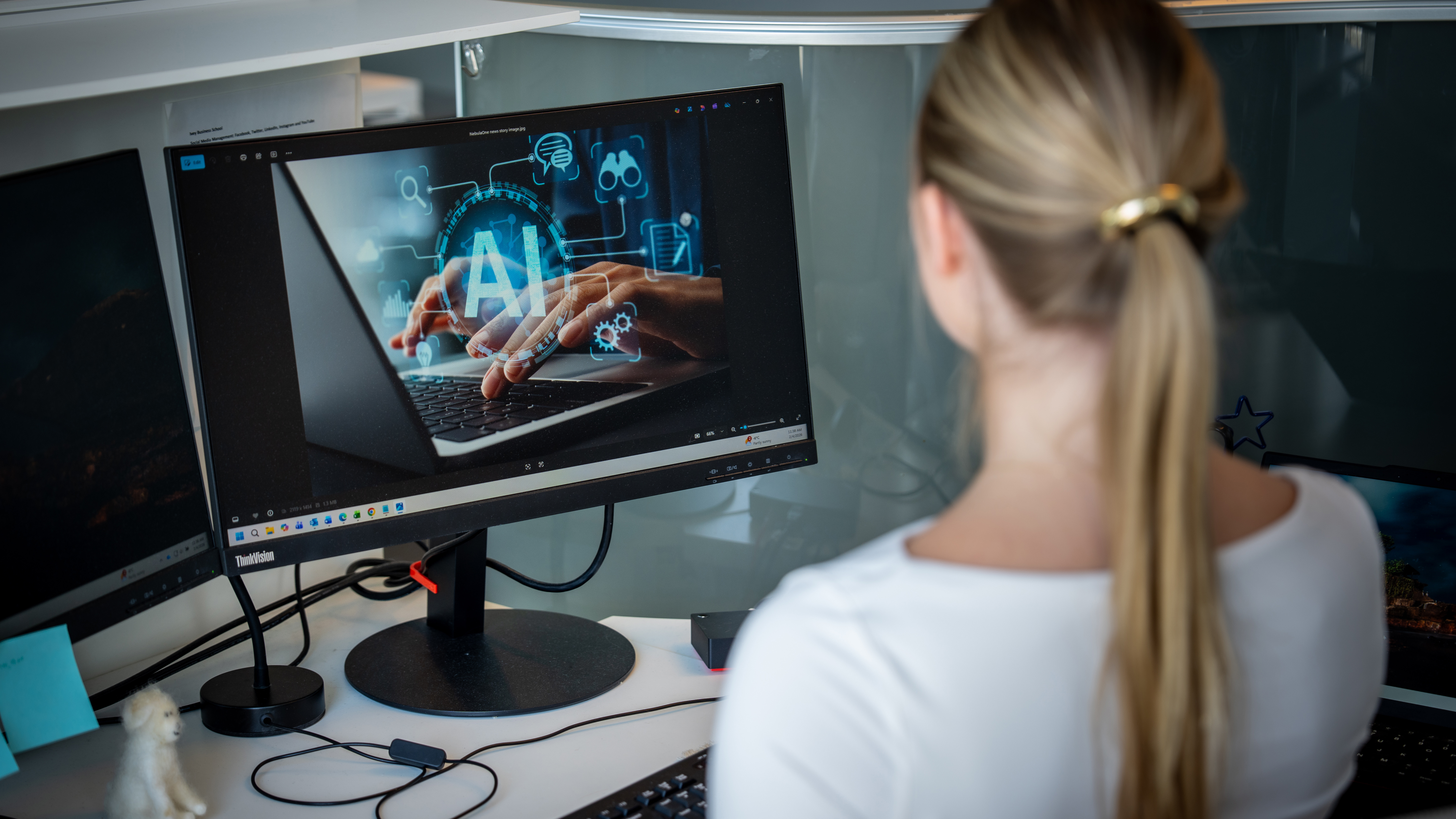 A woman looking at a screen with an AI image on it