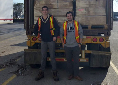 2 shippers smiing in front of Ghana shipment