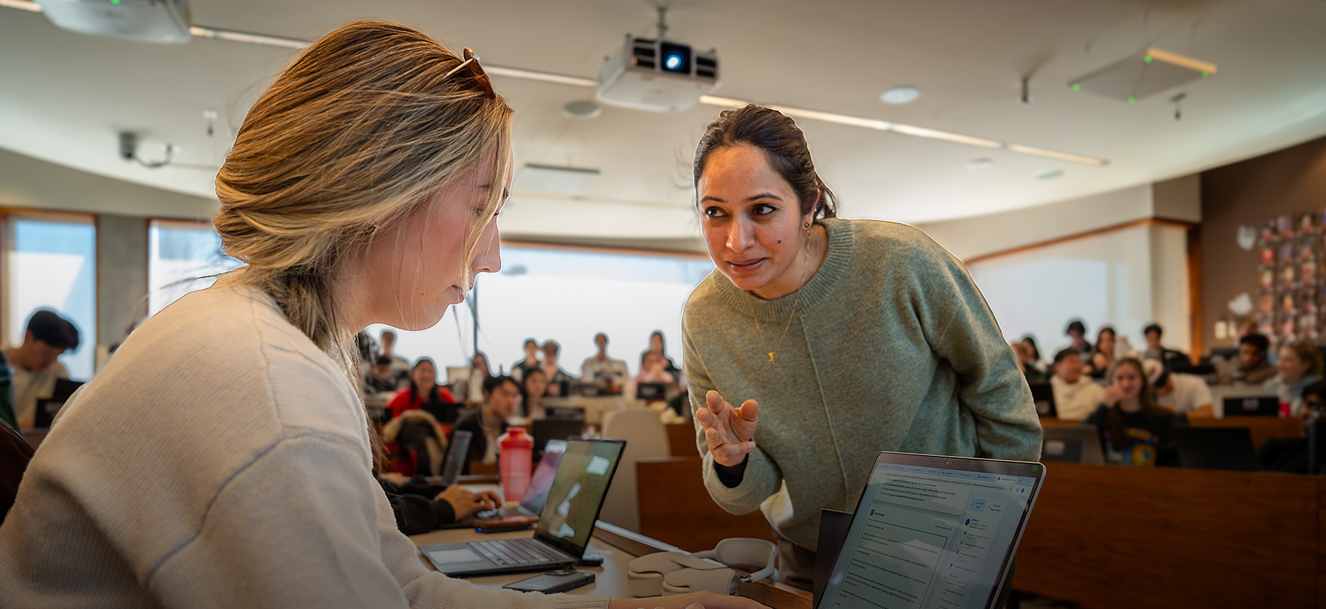 Ivey Assistant Professor Guneet Kaur Nagpal works with HBA student Lily Abboud during a generative AI simulation