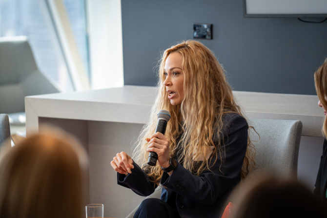 Teanne von der Porten, MBA ’05 answering questions from the moderator and audience