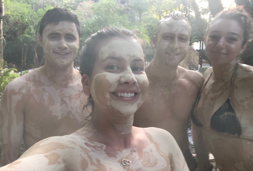 A group of students covered in mud