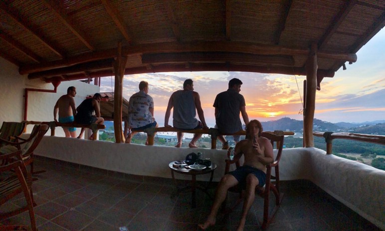 A group of students sitting on a patio