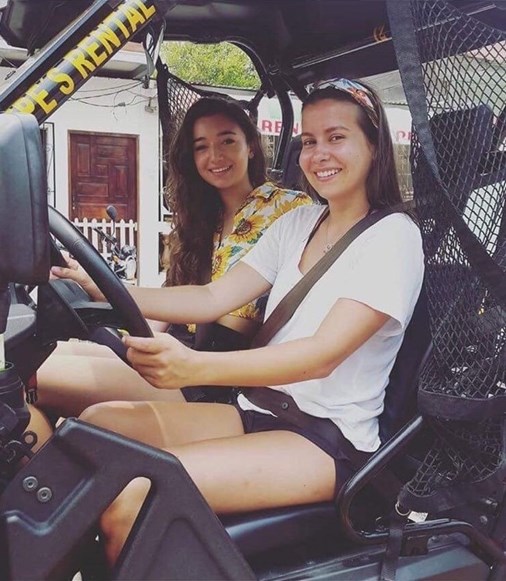 Paula and Mia sitting in an ATV