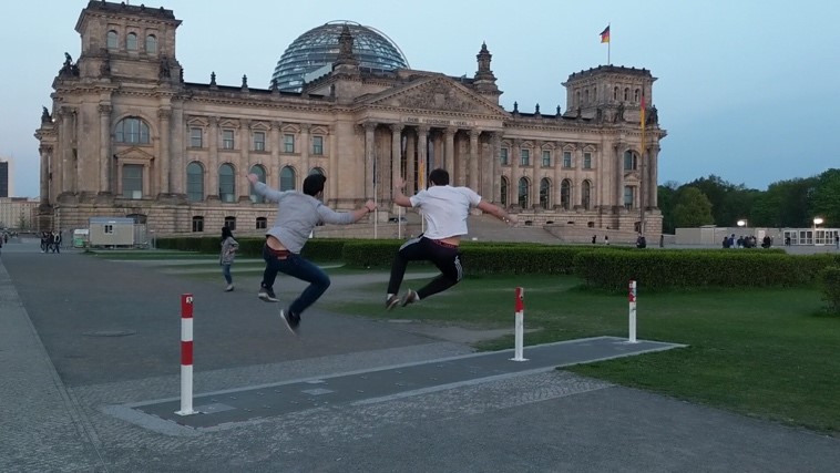 Two men jumping and clicking their heels together