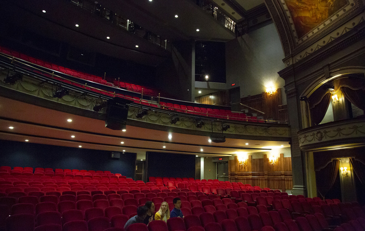 Students sitting inside an empty theatre