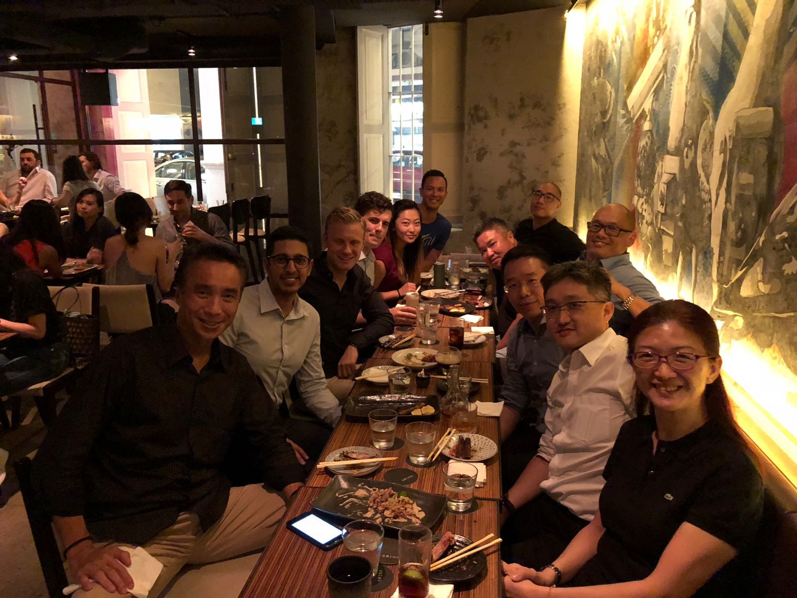 Members of the Singapore Chapter sitting together at a restaurant.
