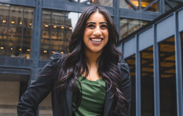 AMBA student posing in front of a downtown Toronto building