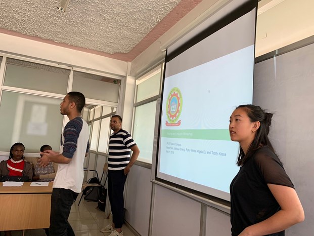 A group of students presenting in a classroom