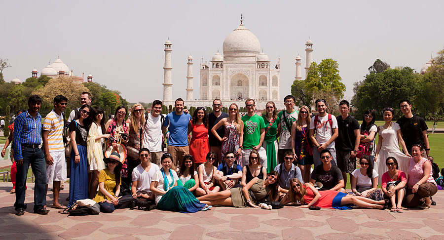 A group of students posing in front of the Taj Mahal