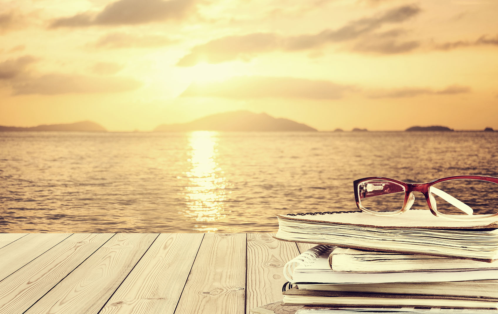 Pile of books on beach