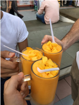 People holding up some smoothies