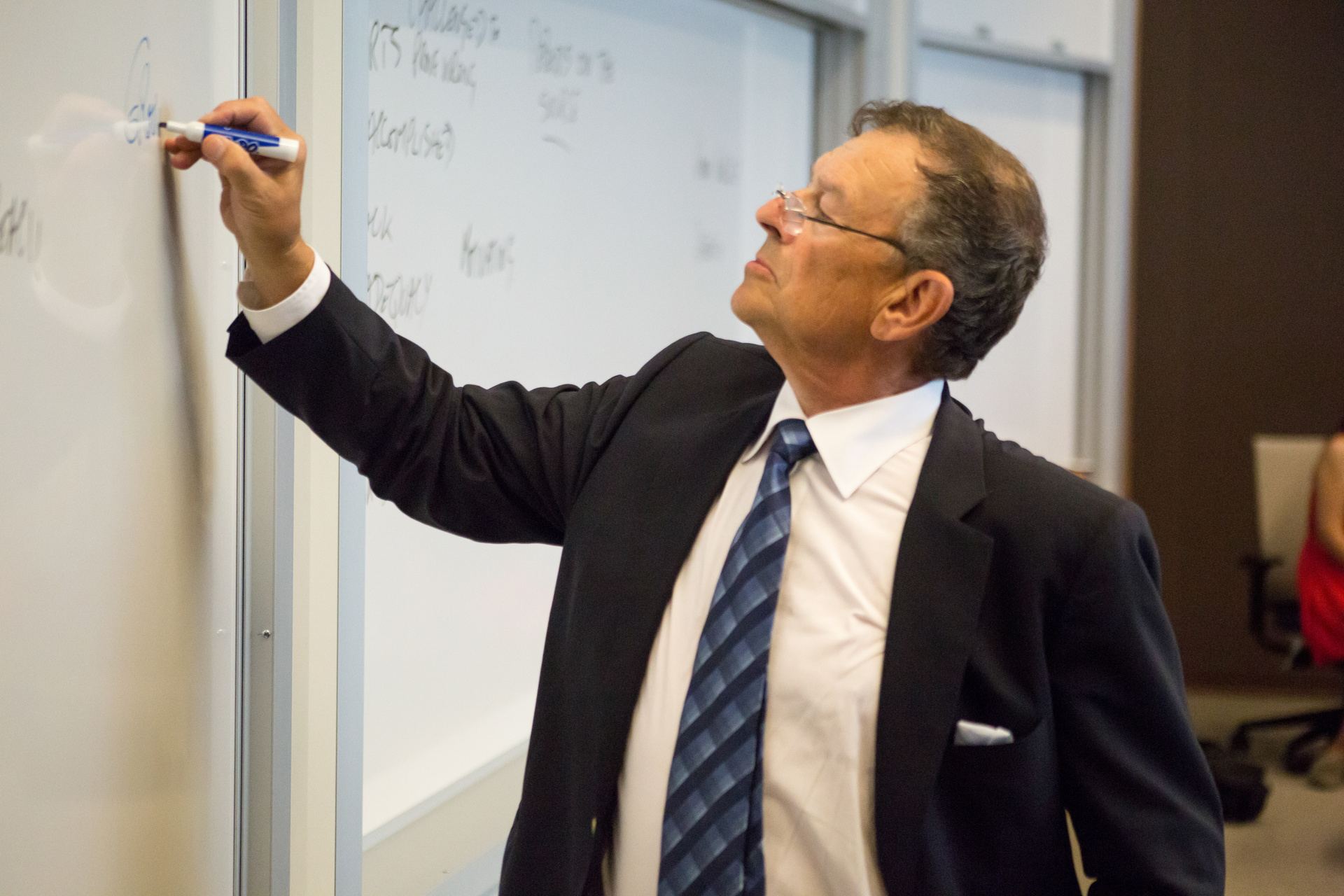 Jeffrey Gandz writing on a whiteboard in a classroom