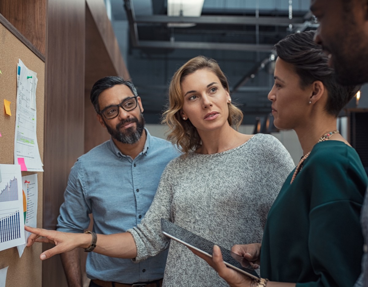 A group of executives talking about a presentation