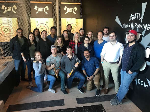 A group of people at an axe throwing facility