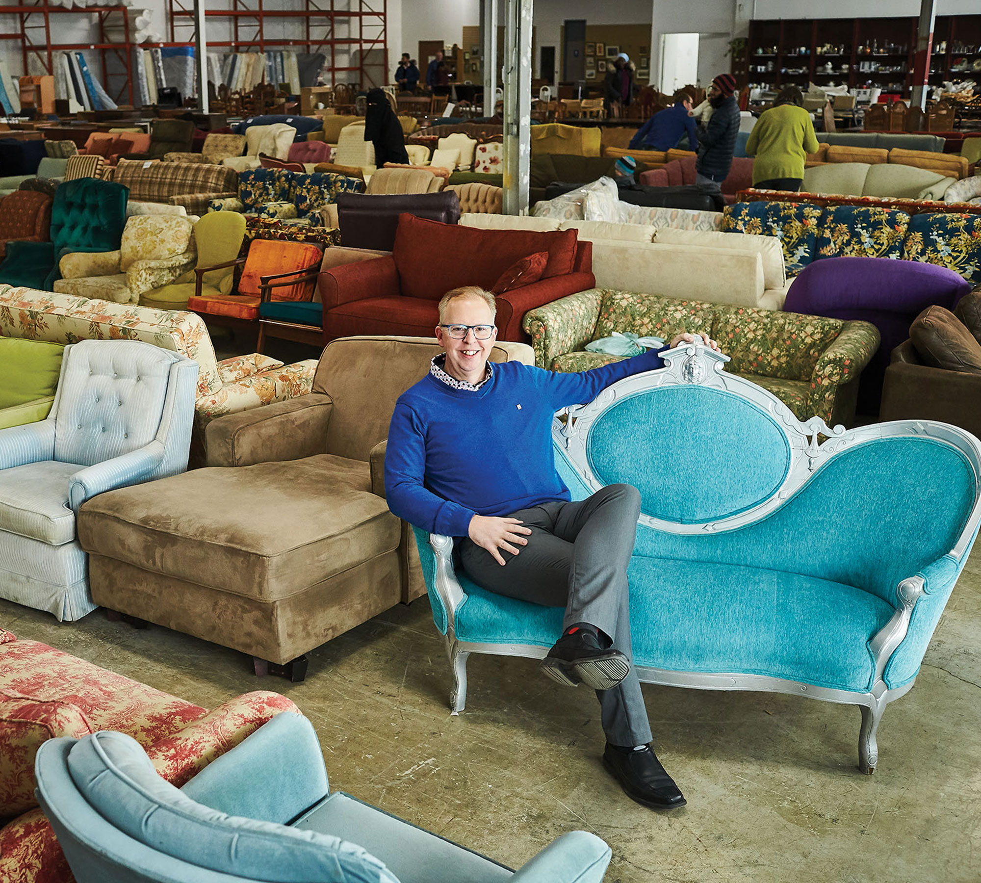  Dan Kershaw sitting in a Furniture Bank store