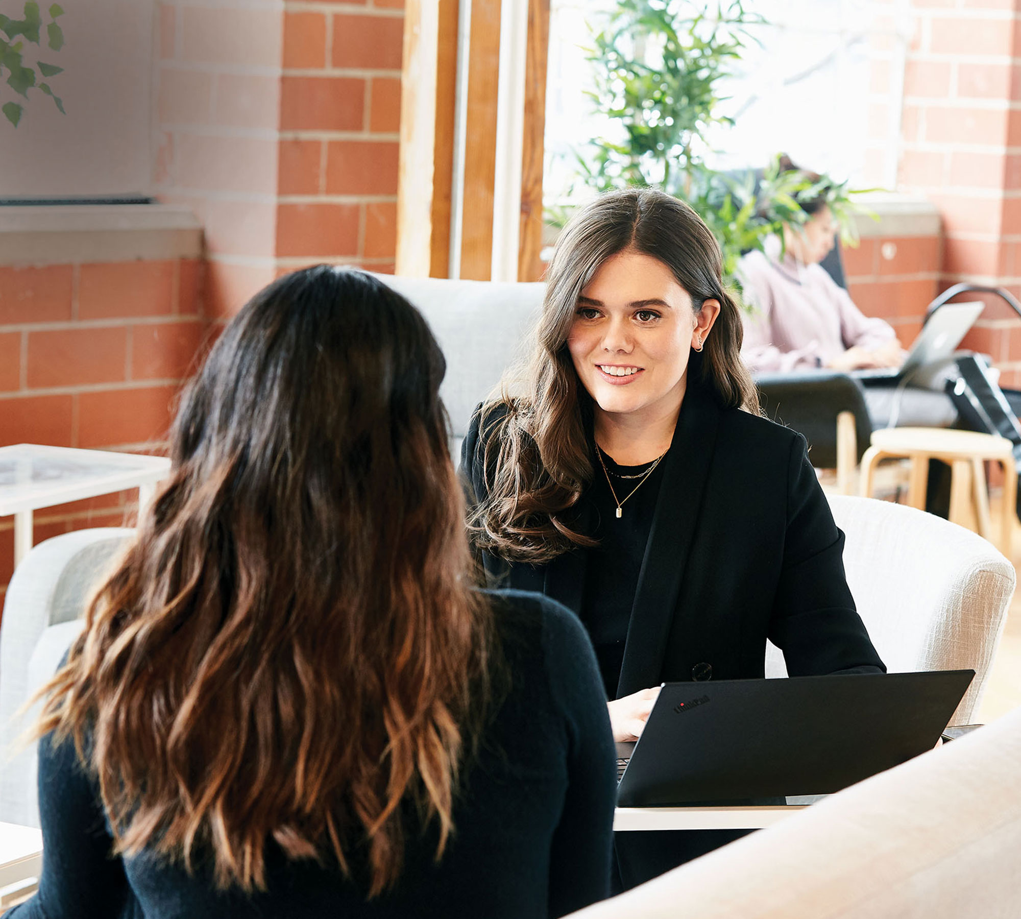 Image of Katie Sellers having a meeting with another woman