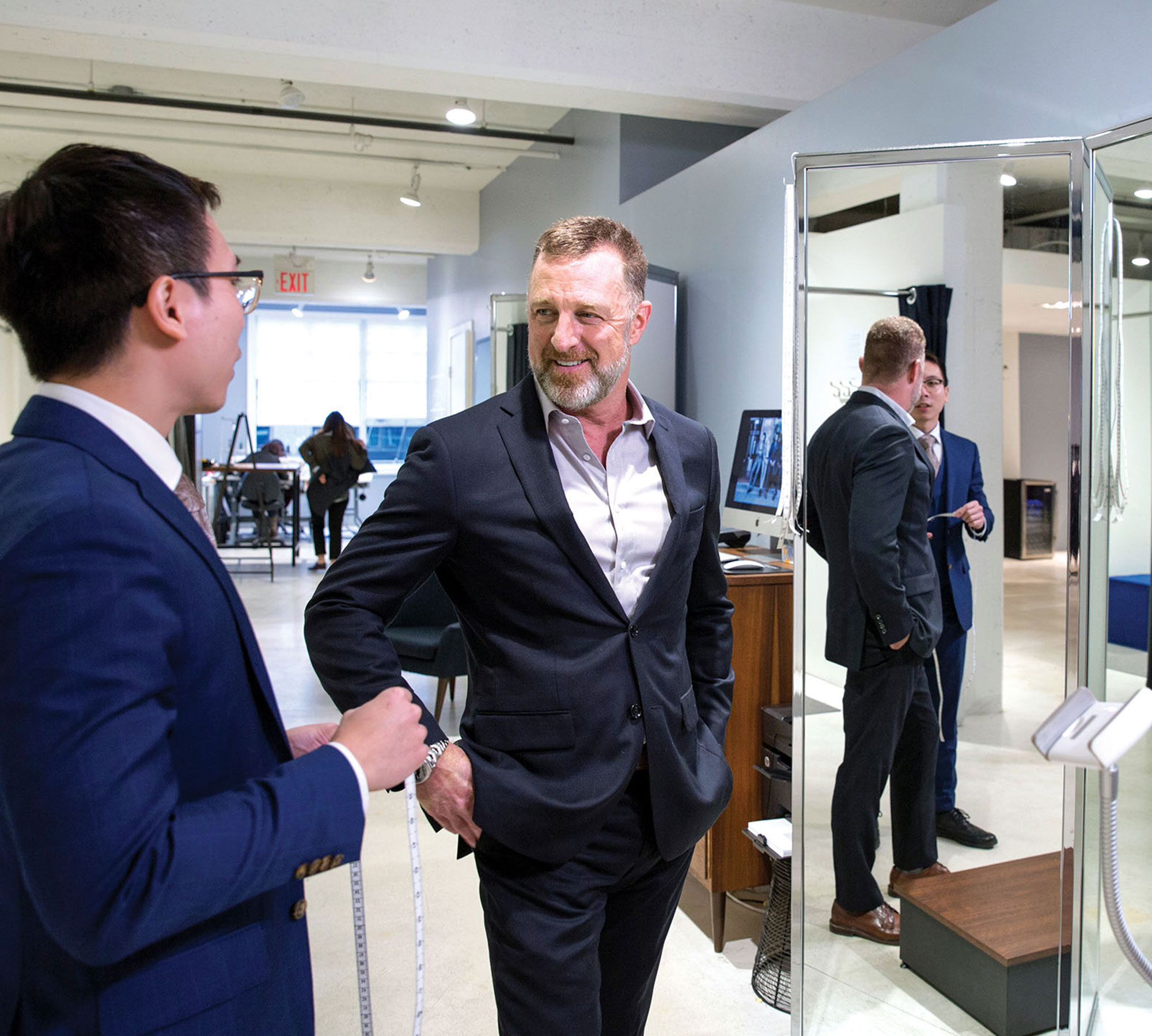 Image of Peter Housley talking with another man in a clothing store