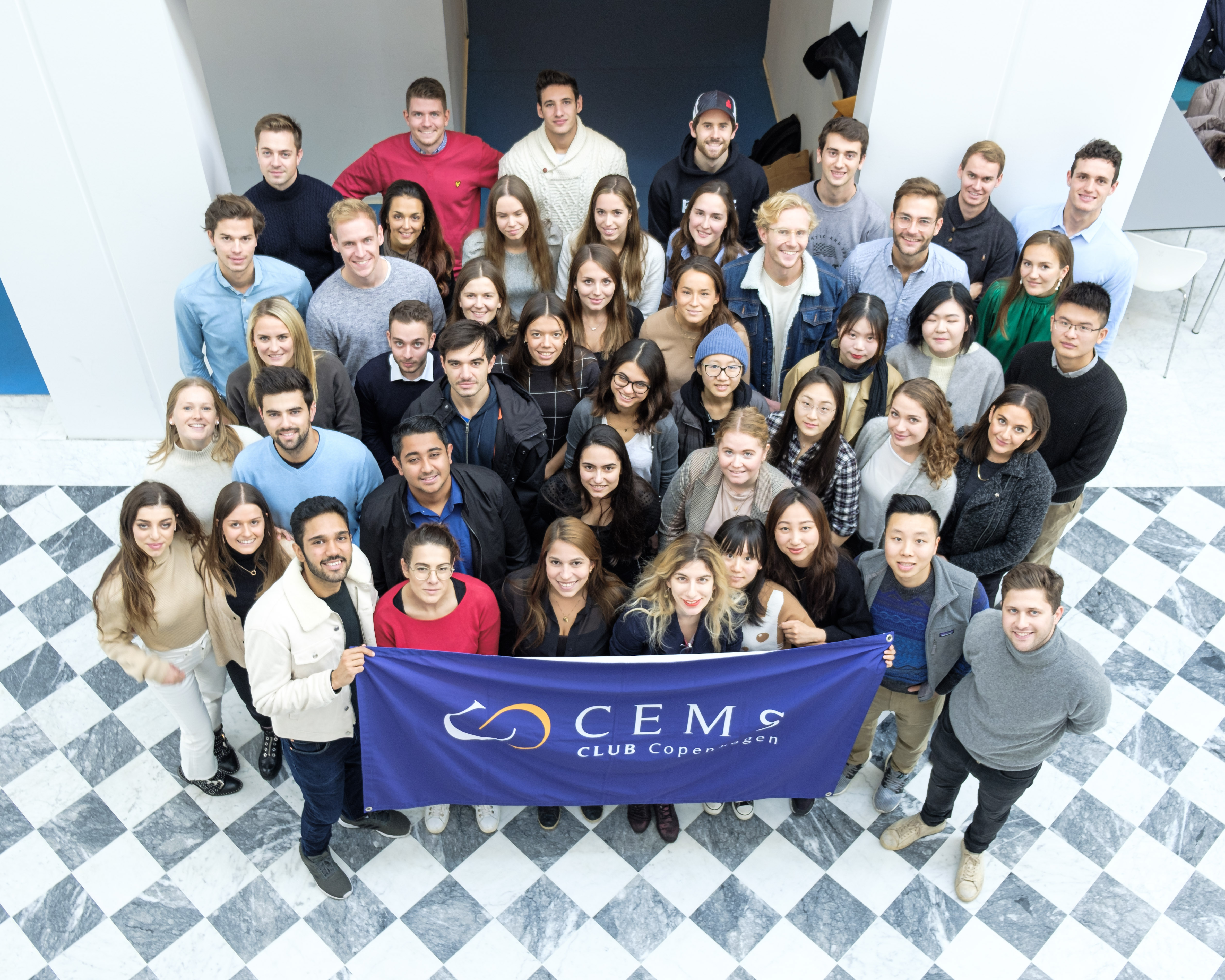 Group of CEMS Students holding the CEMS Flag