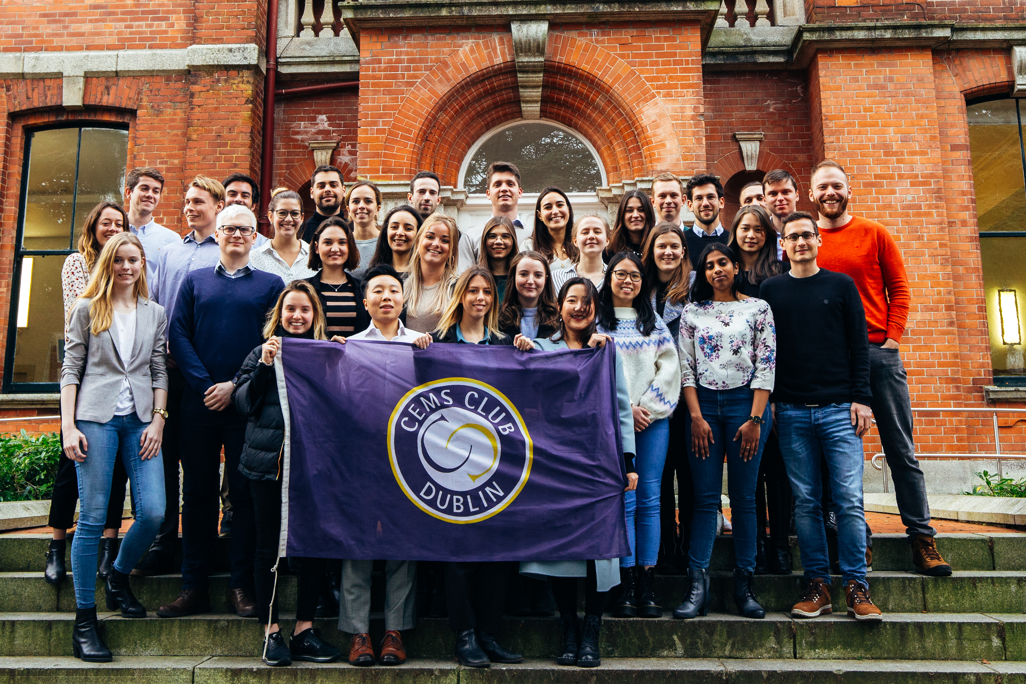 Group of CEMS Students holding the CEMS Club Dublin Flag