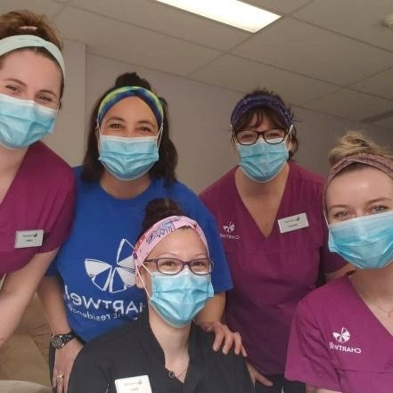 Health-care workers at Chartwell Anne Hathaway Retirement Home wearing headbands from Headbands with Heart