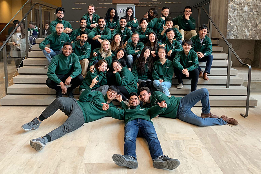 A large group of MSc students posing on some steps in the Ivey Business School.
