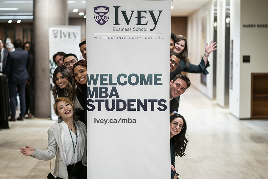 Ivey MBA students posing with welcome banner