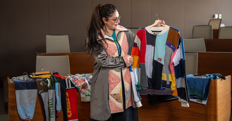 Sumit Nagi holding up GOAT Vintage clothing