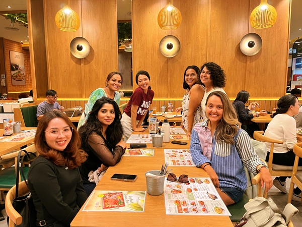 MBA student Maria Talat, second from left, dining in Singapore with friends