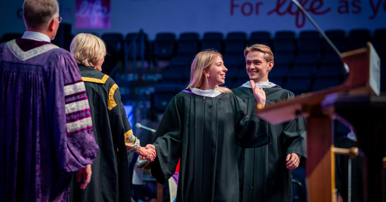 Twins Tim & Marie Haluk (both HBA graduates) receiving their diplomas at Western University's Fall Convocation