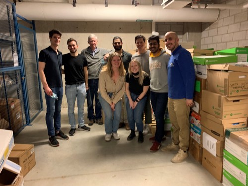 Ivey MSc students helping to pack books for the 39 Country Initiative