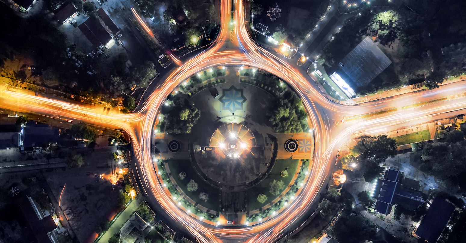 Abstract city highlighting a glowing roundabout with nature surrounding