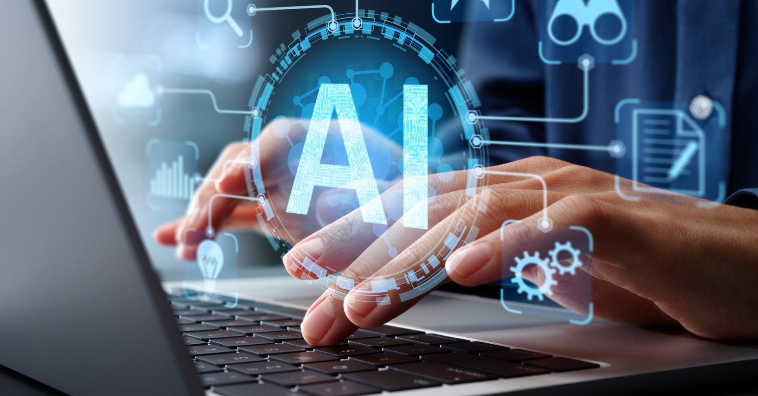 Person typing on a laptop keyboard with the text AI overlayed