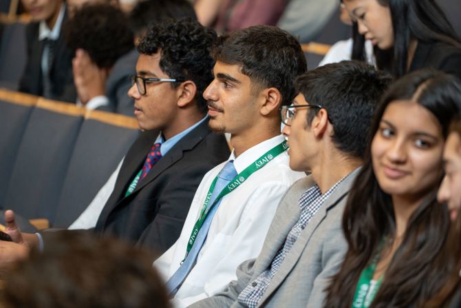 Students watching a presentation in auditorium