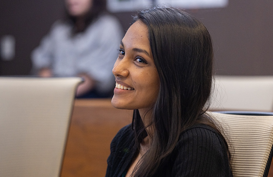 A student smiling in a classroom