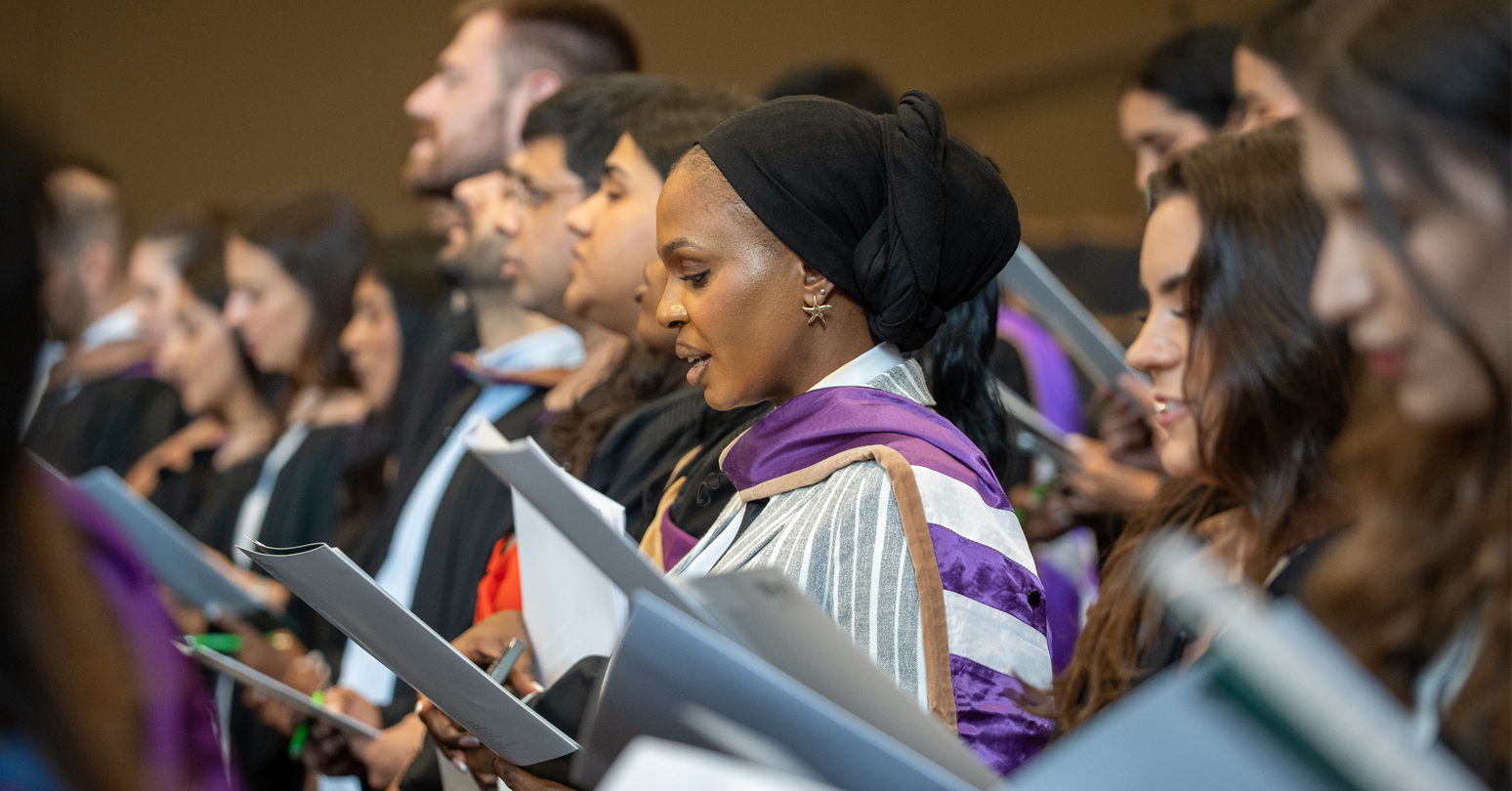 A group of Ivey graduates taking the pledge