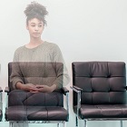 Woman of colour sitting in a chair