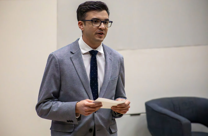 MBA student Nico Mendoza introducing Dennison Veru