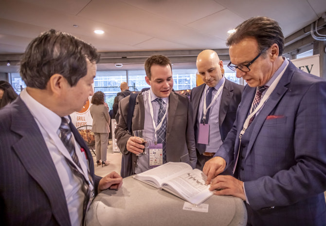 Francis Chou & George Athanassakos reviewing George's book with AGM attendees