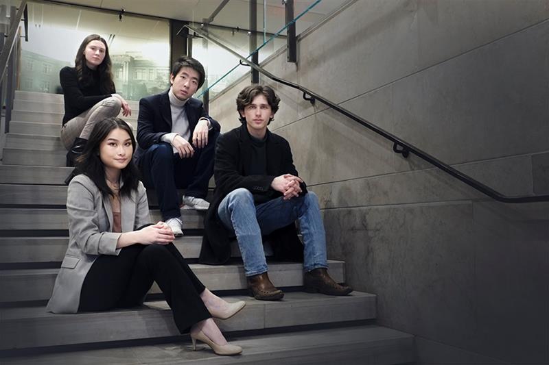 ben, alice, iulia and nick sitting in hallway