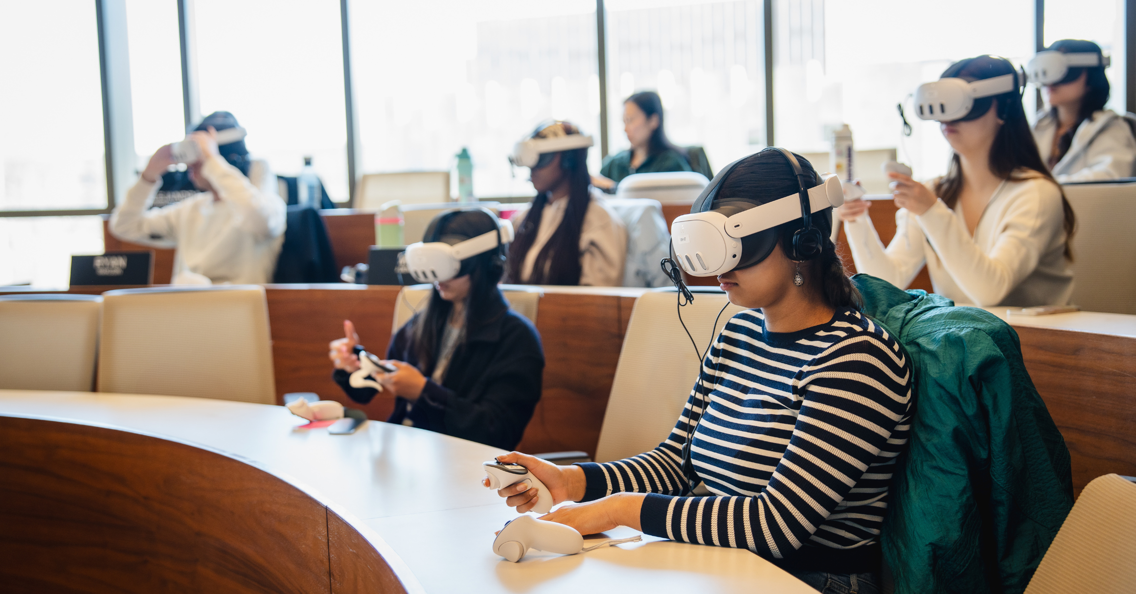 An Amphitheater Style Classroom Where Five Students Sit Wearing VR Headsets