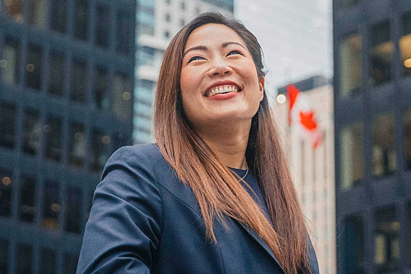 A smiling woman in downtown Toronto